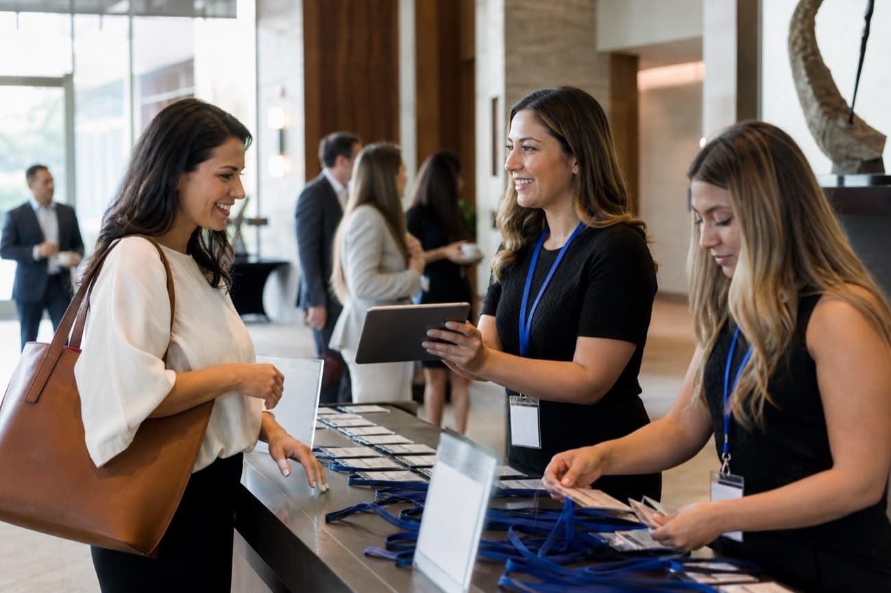 Guests checking in at the registration desk of a chamber event